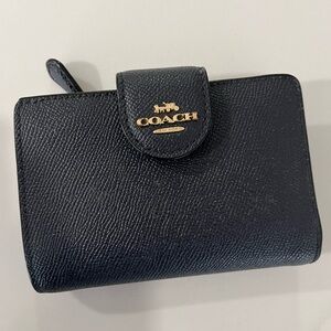 Navy coach wallet with gold hardware
